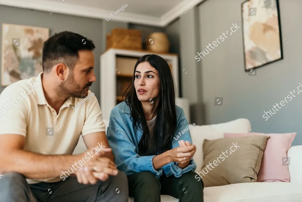 A couple talking together on a sofa